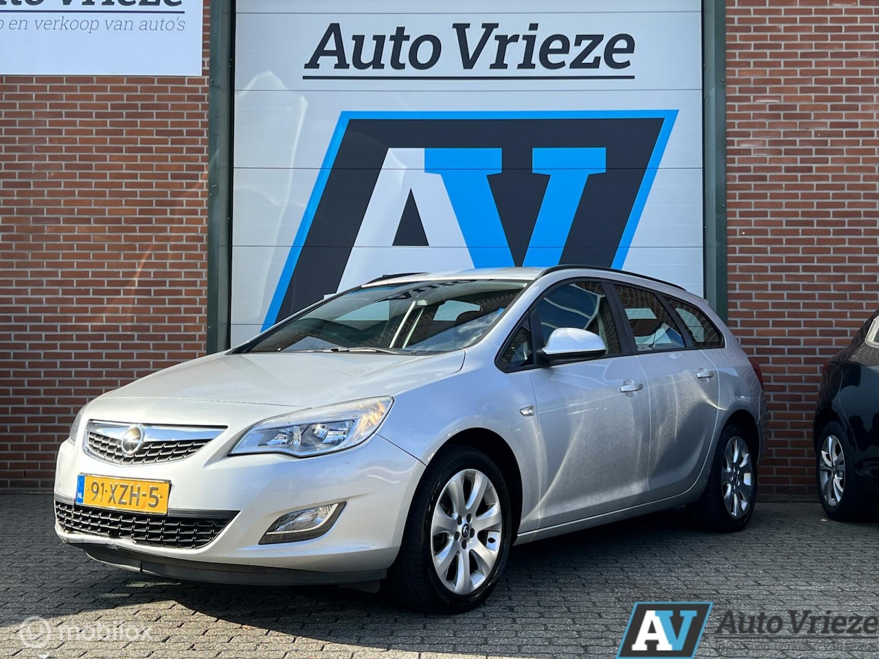 Opel Astra Sports Tourer - 1.4 Cosmo 1.4 Cosmo, Airco, Trekhaak - AutoWereld.nl