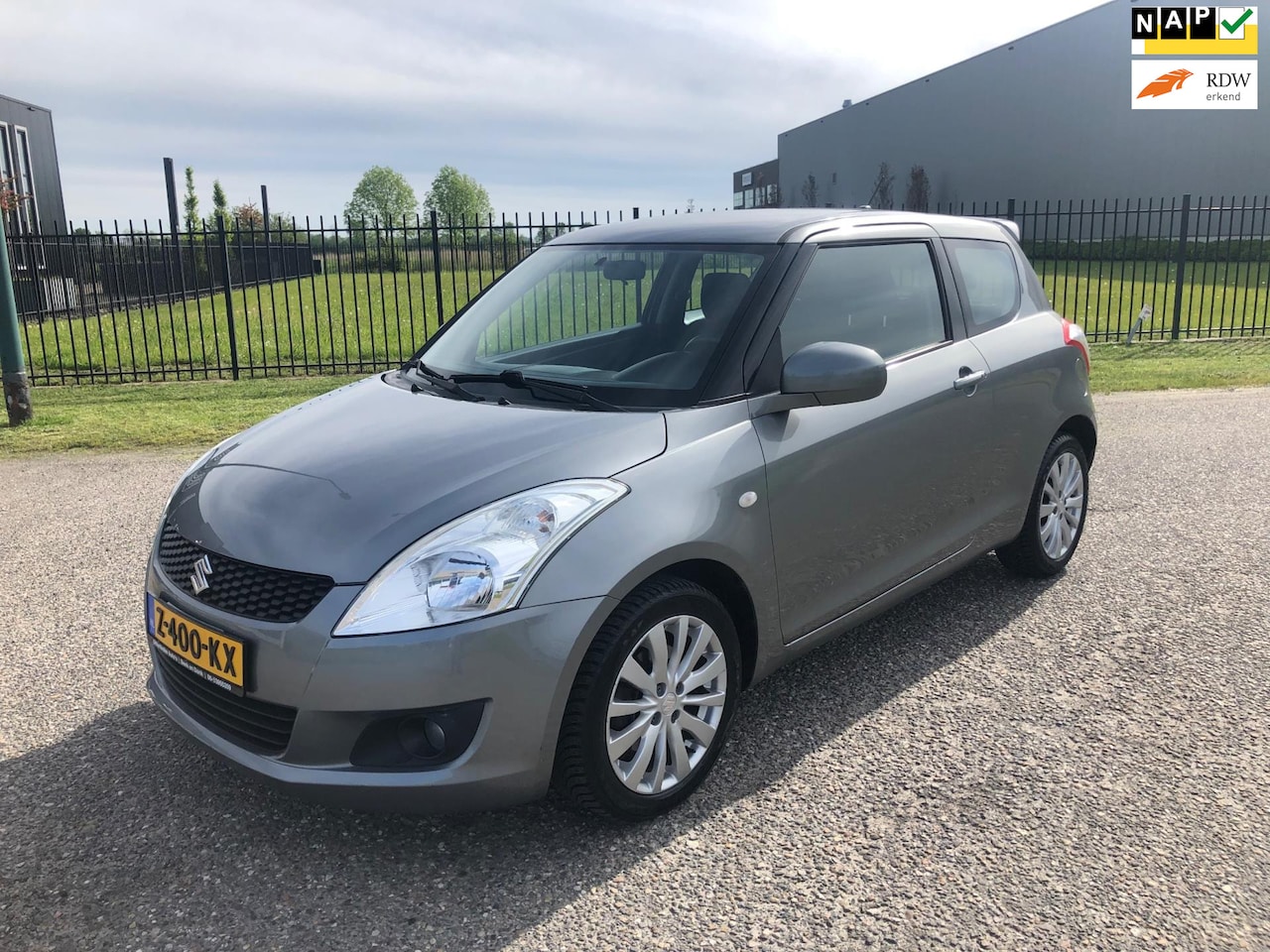 Suzuki Swift - 1.2 Comfort EASSS Bj 2012 Clima Cruise Keyless Stoelverwarming Apk 4-2025!! - AutoWereld.nl