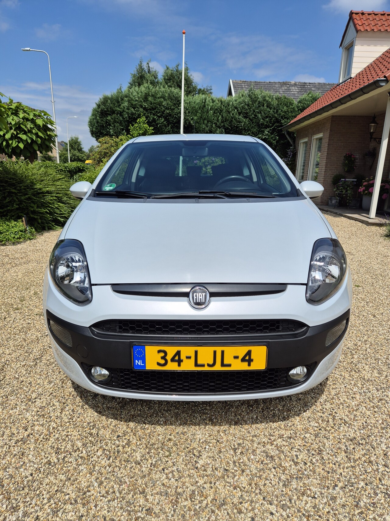 Fiat Punto Evo - 1.4 Racing Originele Navigatiesysteem - Armsteun - Sportonderstel - Privacy glass - Originele TOMTOM - AutoWereld.nl