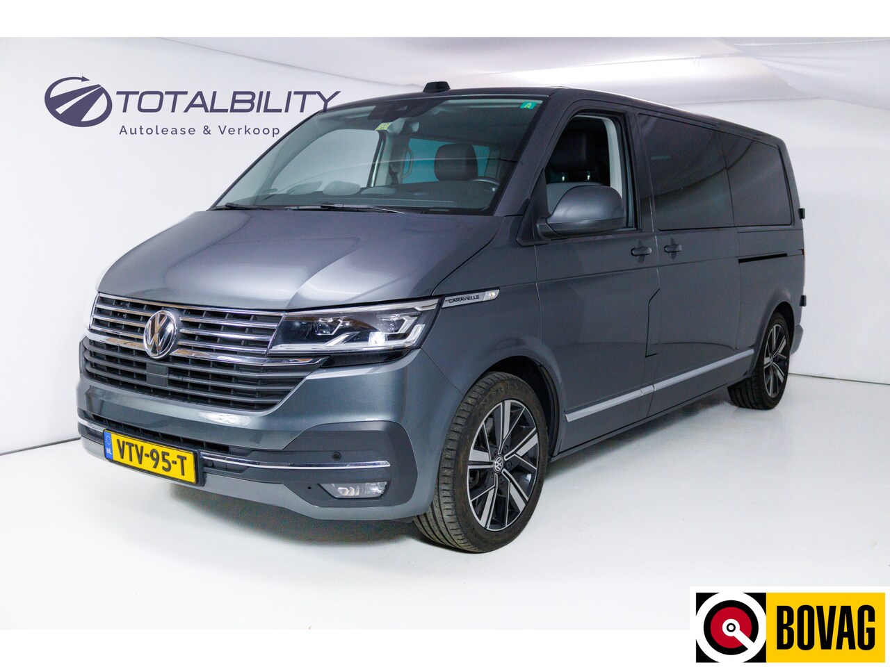 Volkswagen Transporter Caravelle - 2.0 TDI L2H1 32 DC Caravelle Highline 204 pk Electrische schuifdeur l+r, Leer, Afn.trekhaa - AutoWereld.nl