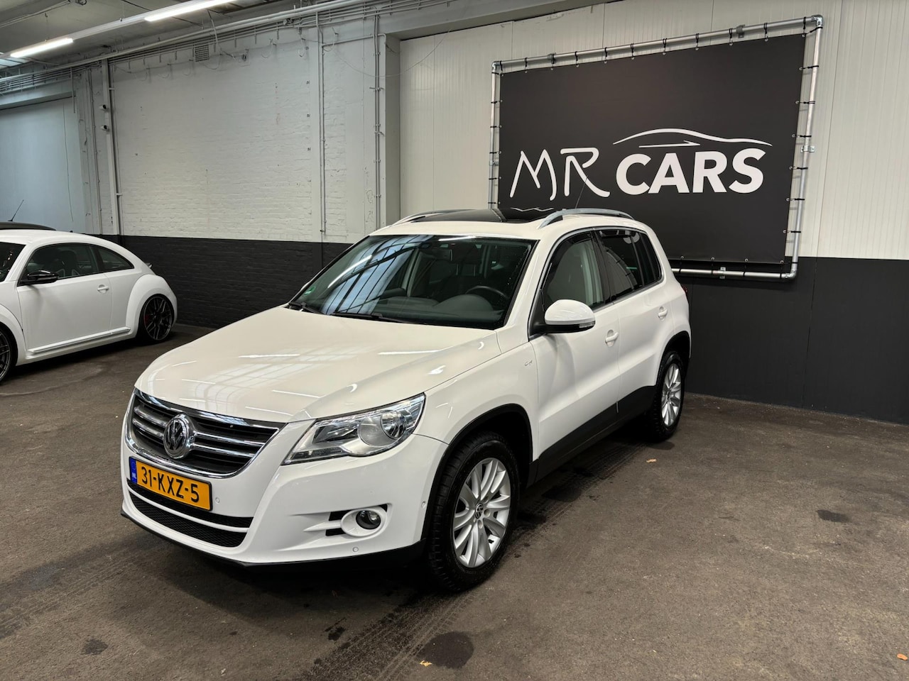 Volkswagen Tiguan - 2.0 TSI Sport&Style 4Motion Panodak/Camera/Navi - AutoWereld.nl