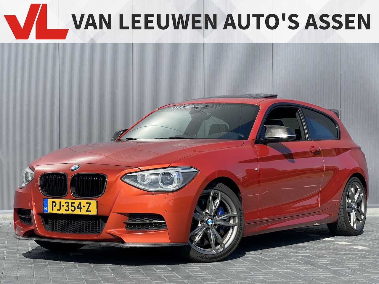 BMW 1-serie - M135i High Executive | Valencia Orange! | Volle auto - AutoWereld.nl