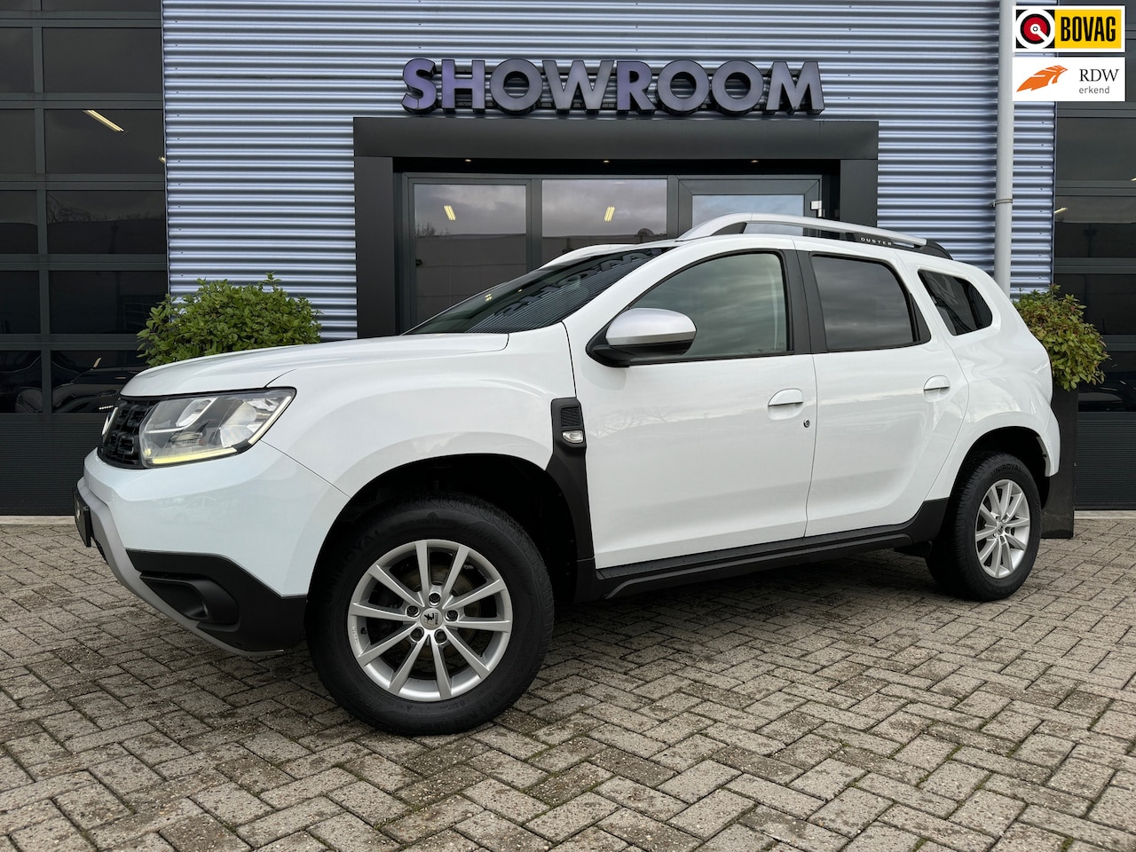 Dacia Duster - 1.6 SCe Comfort Navi|Camera|Cruise|Airco| 2 velgensets - AutoWereld.nl