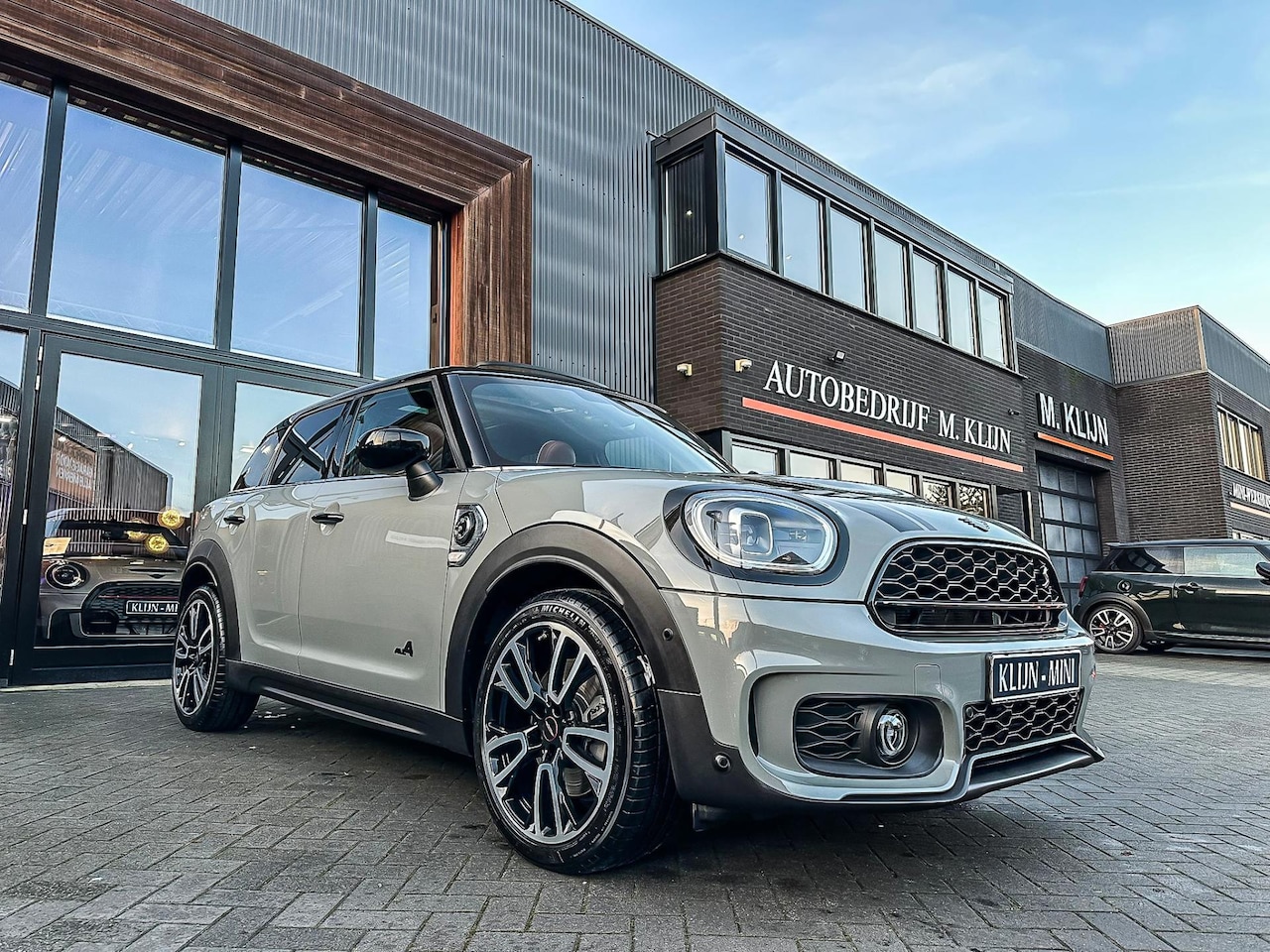 MINI Countryman - Mini 2.0 Cooper S E ALL4 John Cooper Works 220pk/Nardo/Pano/HK/Camera/Btw/Vol - AutoWereld.nl