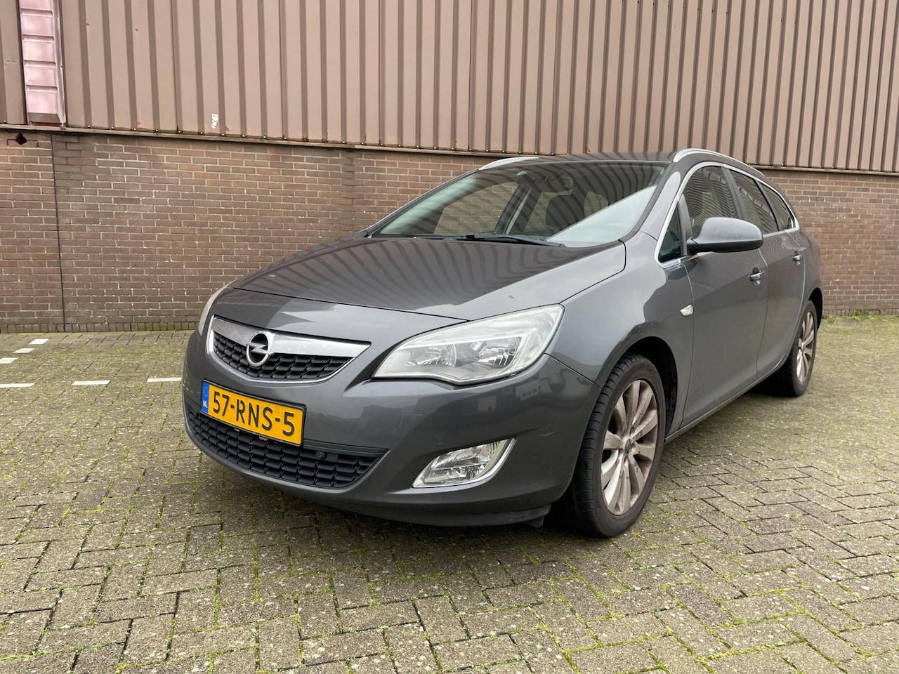 Opel Astra Sports Tourer - 1.4 Cosmo Navi Cruise AIRCO Leer PDC - AutoWereld.nl