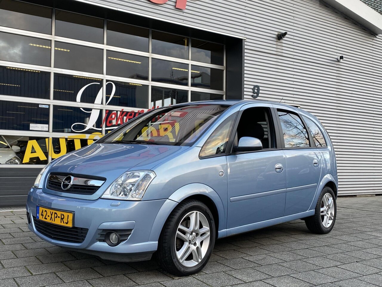 Opel Meriva - 1.6-16V Cosmo - Navigatie I Airco I PDC I Xenon I Afneembare trekhaak I Sport velgen I APK - AutoWereld.nl