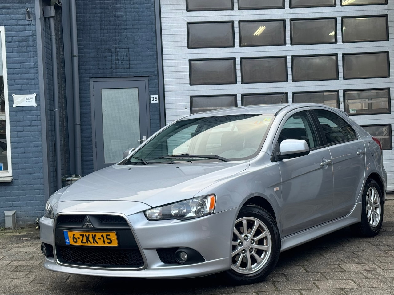 Mitsubishi Lancer Sportback - 1.6 Limited Edition | Airco | Cruise | PDC - AutoWereld.nl