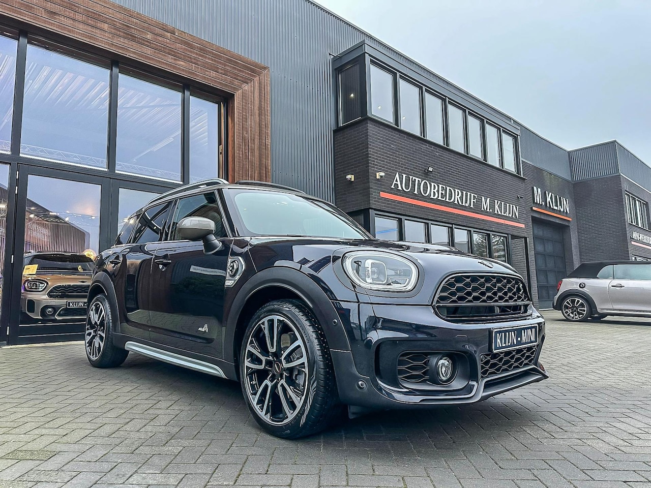 MINI Countryman - Mini 2.0 Cooper S E ALL4 John Cooper Works 220pk/Pano/Camera/Lounge leder/19"Jcw/Btw - AutoWereld.nl