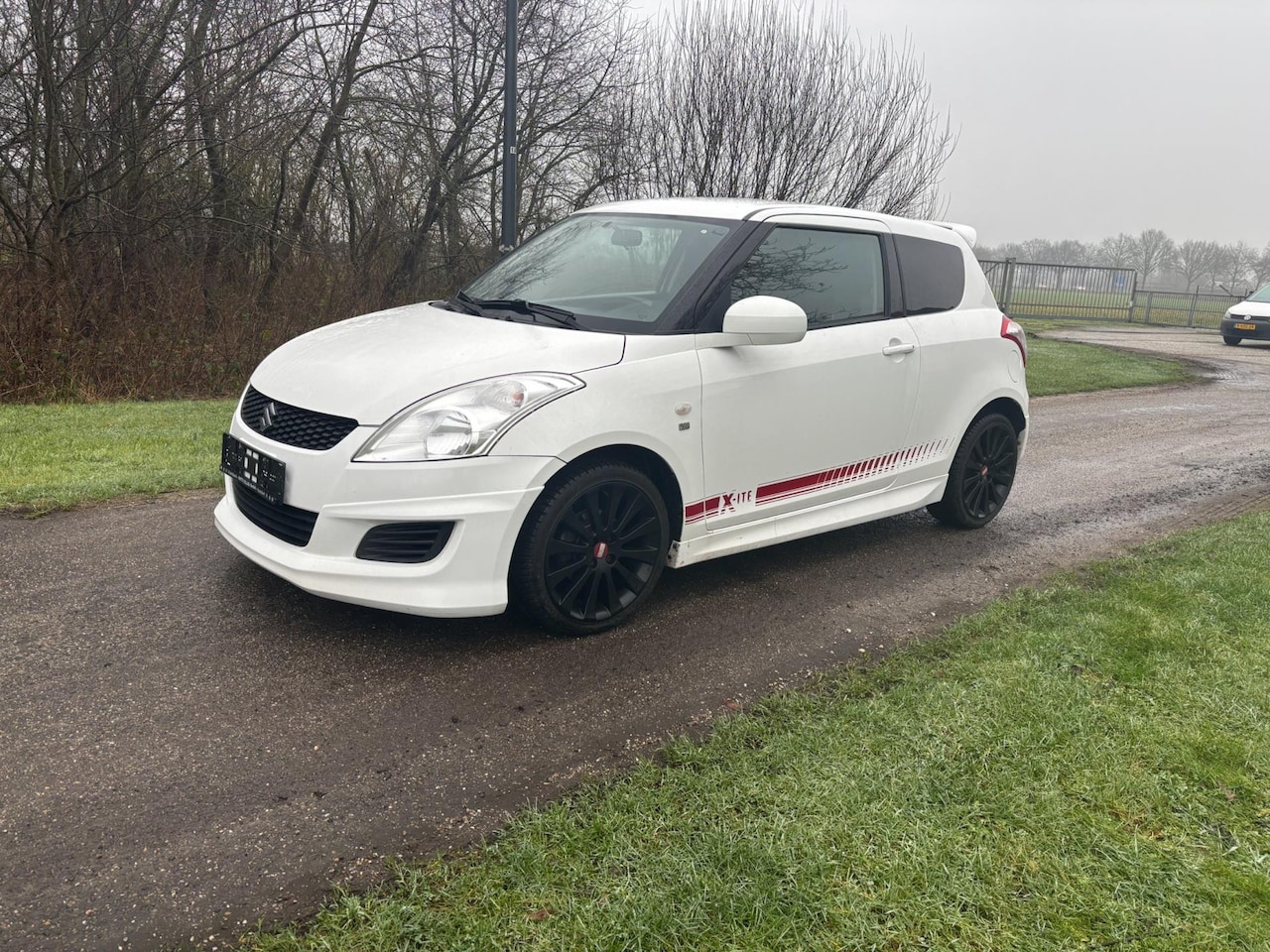 Suzuki Swift - 1.2 Exclusive EASSS X-ite Xite 6 maanden garantie - AutoWereld.nl