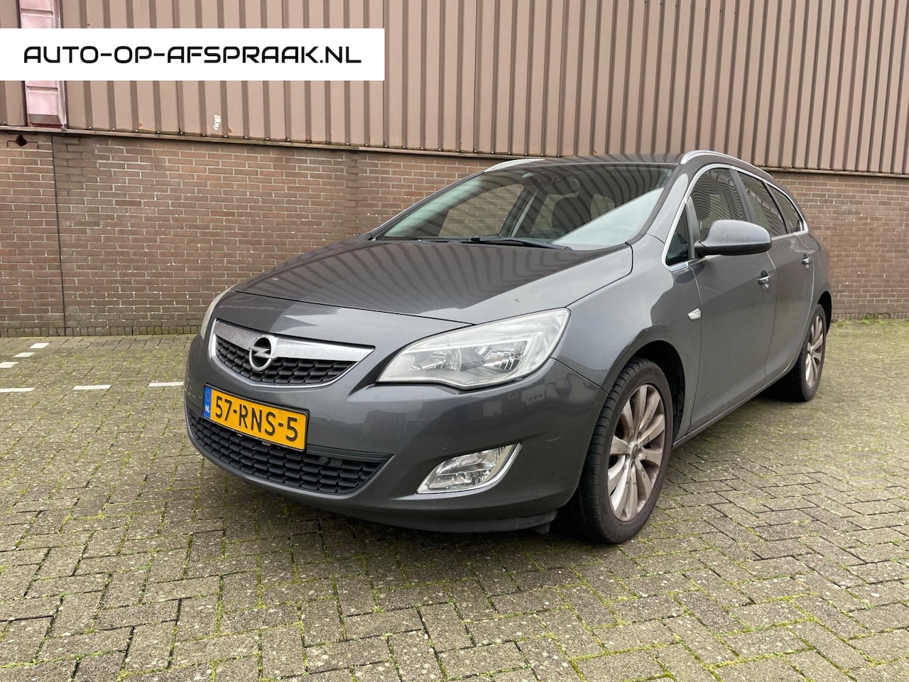 Opel Astra Sports Tourer - 1.4 Cosmo Navi Cruise AIRCO Leer PDC - AutoWereld.nl