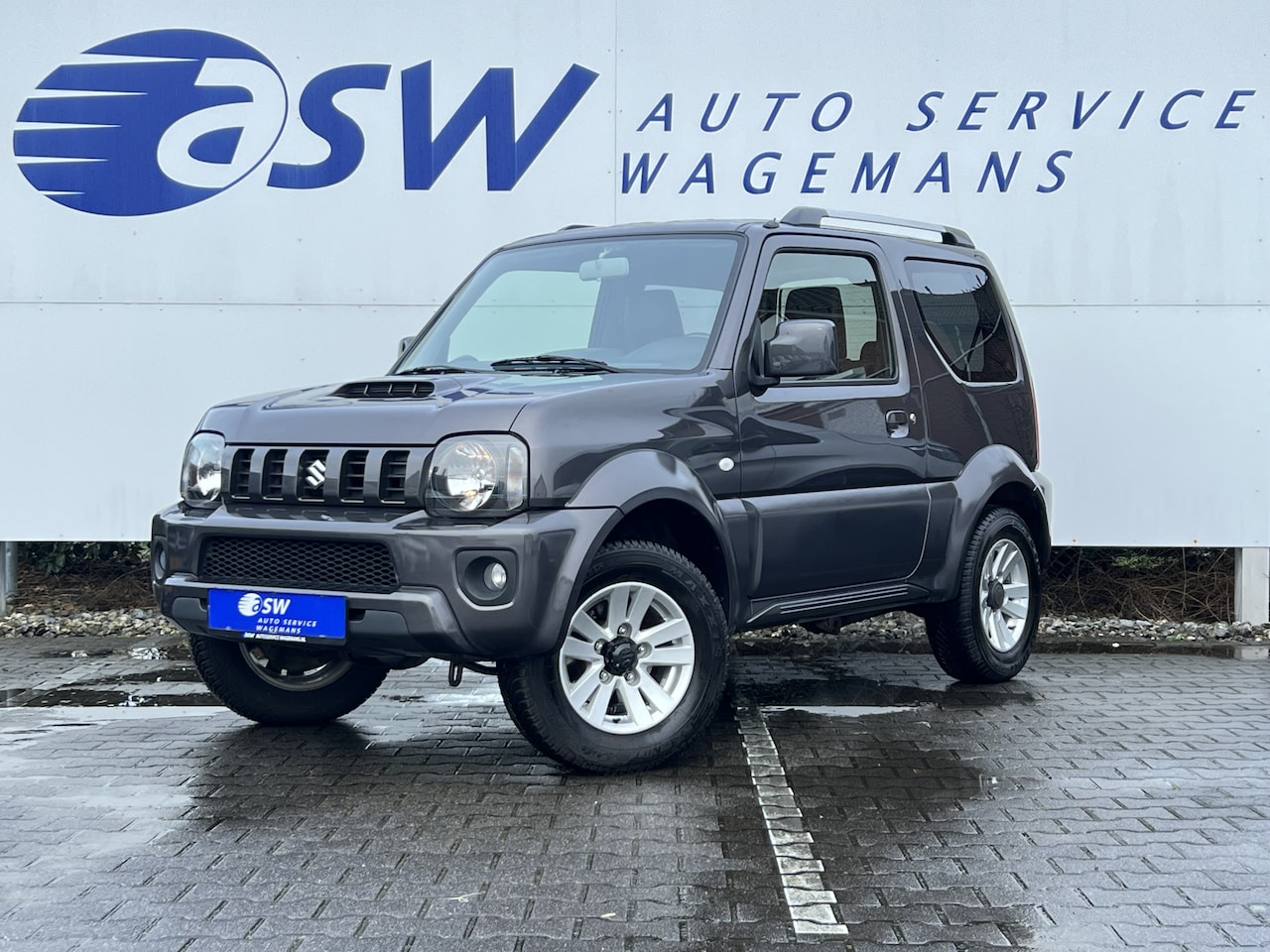 Suzuki Jimny - 1.3 Exclusive | 4X4 | Trekhaak | Airco | Leder | Reservewiel - AutoWereld.nl