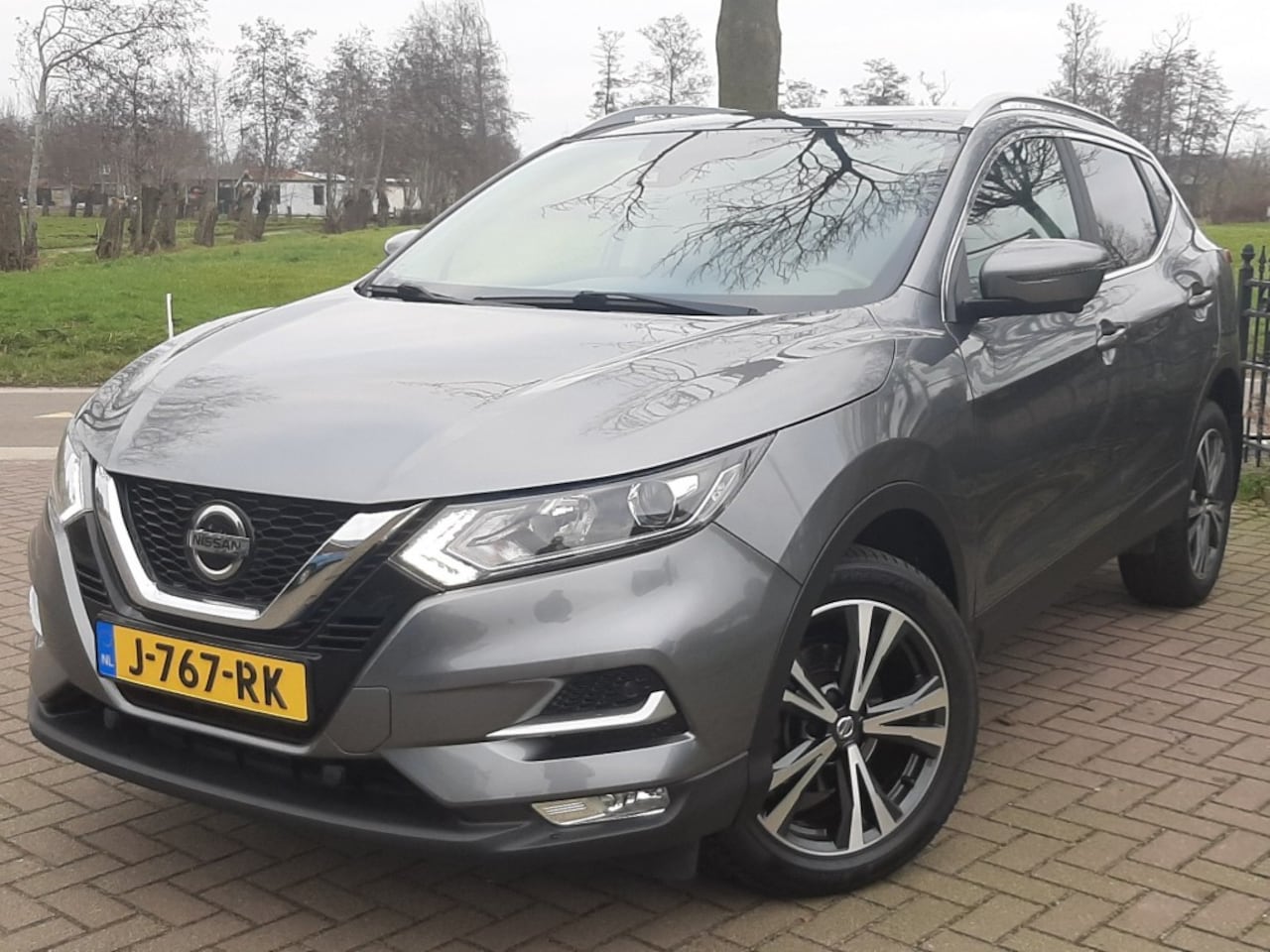 Nissan Qashqai - 1.2 115pk Automaat Airco Cruise-control Bluetooth Navigatie Half - AutoWereld.nl