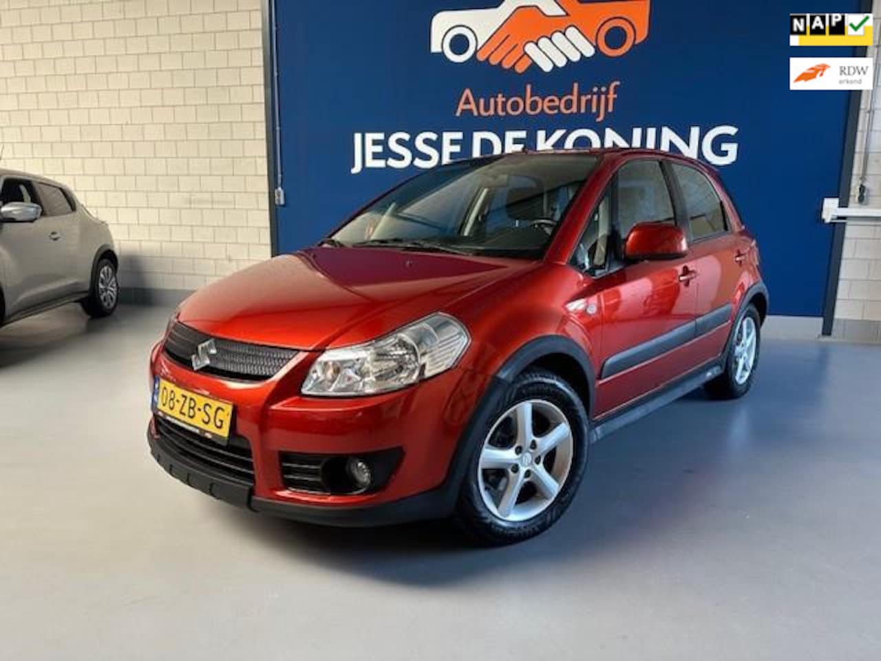 Suzuki SX4 - 1.6 Exclusive automaat,bj.2007,kleur:rood,climate,trekhaak,sportvelgen,airco,etc.NAP met 1 - AutoWereld.nl