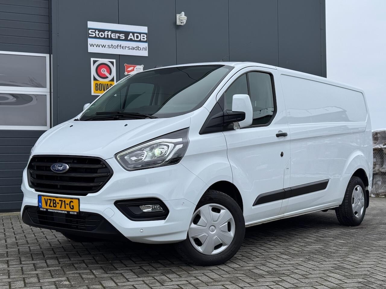 Ford Transit Custom - 320 2.0 EcoBlue L2H1 Trend 131pk | Airco | Trekhaak | Cruise | Bluetooth | Parkpack | Laad - AutoWereld.nl