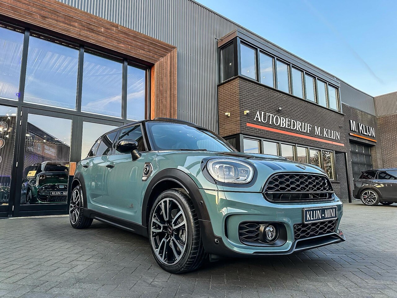 MINI Countryman - Mini 2.0 Cooper S E ALL4 John Cooper Works Sage Green/Pano/Leer/Camera/19"/Btw - AutoWereld.nl