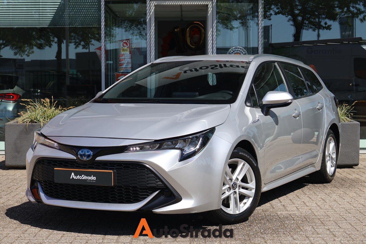 Toyota Corolla Touring Sports - 1.8 Hybrid Active 122pk I Navi I Camera I Climate I Cruise I 1e eigenaar - AutoWereld.nl