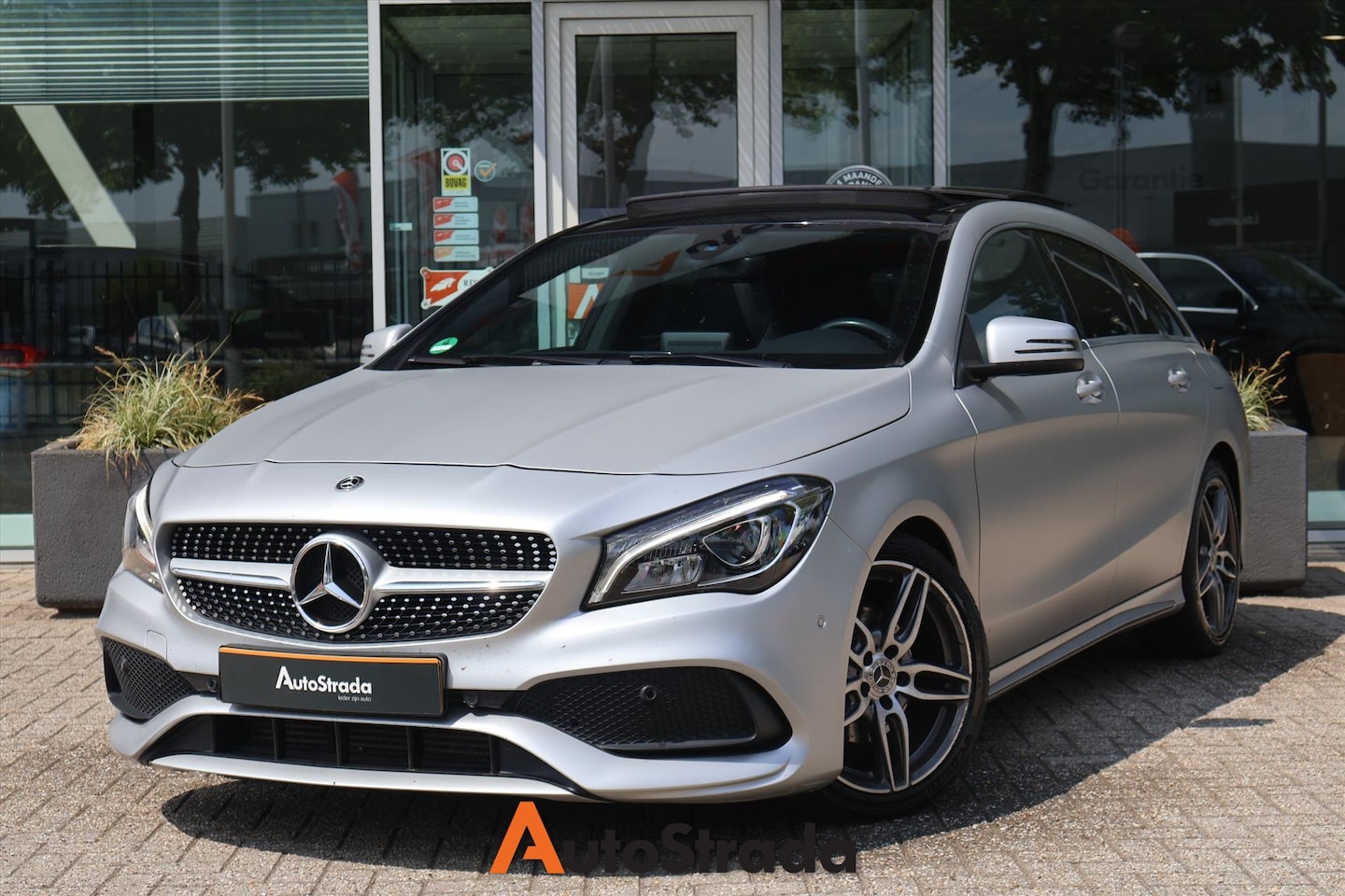 Mercedes-Benz CLA-klasse Shooting Brake - 180 AMG-Line 122pk | Camera | Keyless Go | Pano | Cruise | Airco | Navi | Magno Polarzilve - AutoWereld.nl