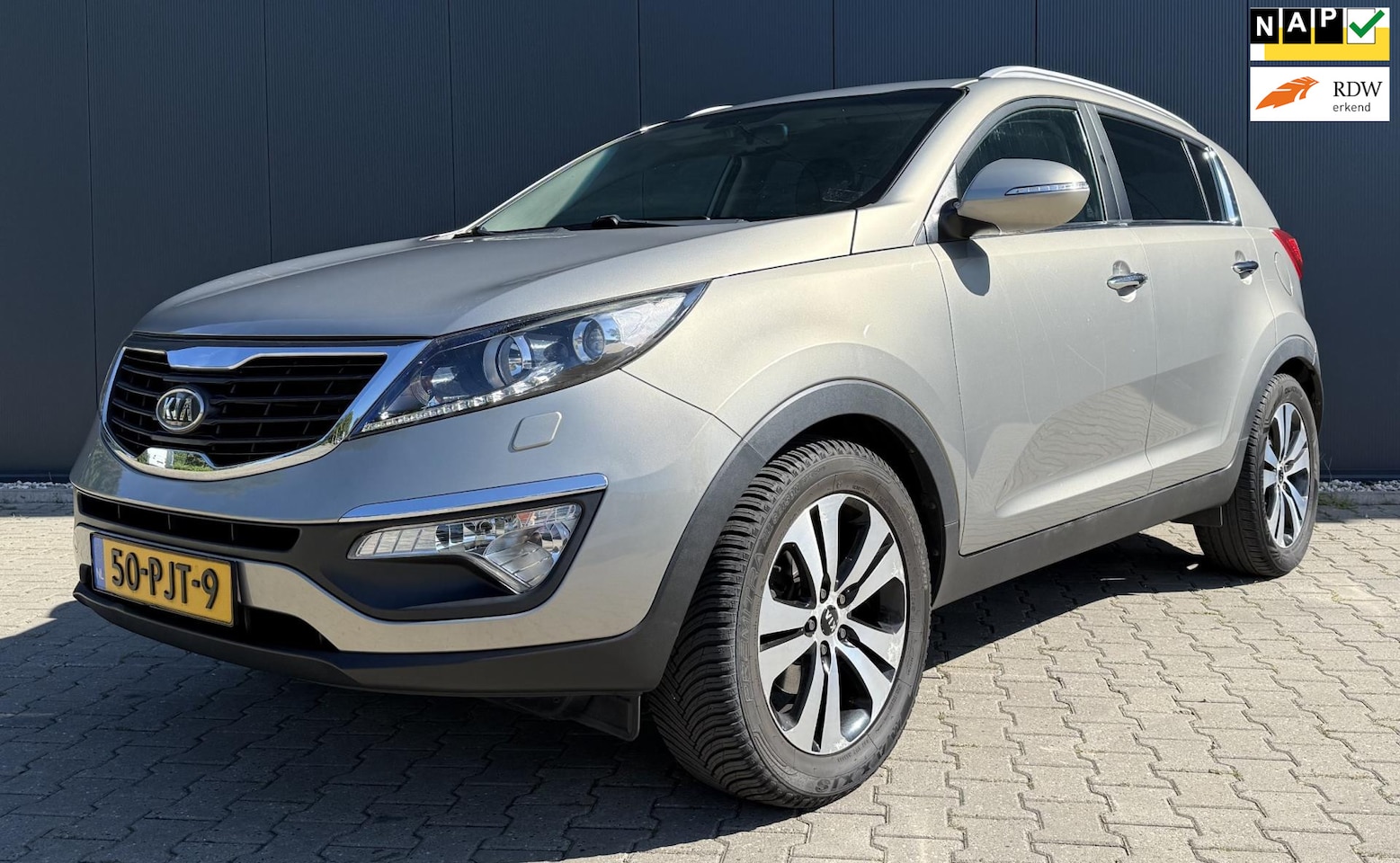 Kia Sportage - 2.0 X-clusive Airco Cruise Navi Camera Automaat - AutoWereld.nl