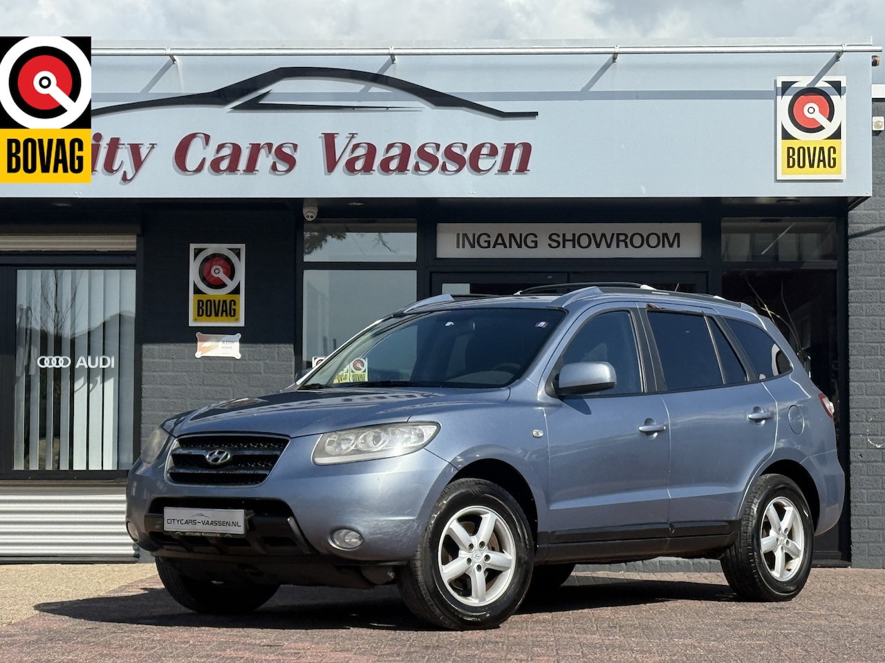 Hyundai Santa Fe - 2.7i V6 Dynamic 7p. export climate ctr cruise ctr parrot systeem trekhaak lmv 16 inch - AutoWereld.nl