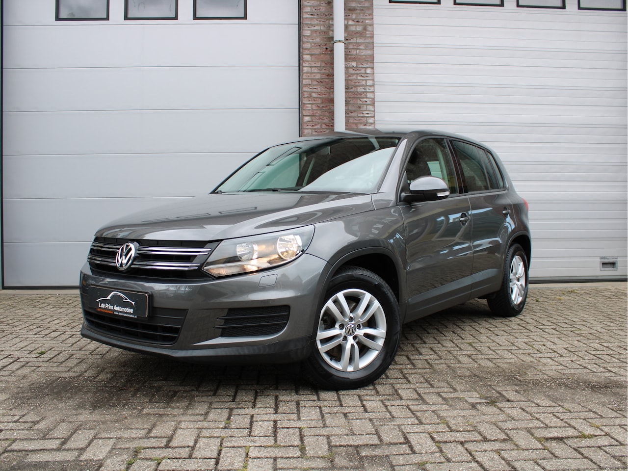 Volkswagen Tiguan - 1.4 TSI Comfort&Design Edition Afneembare trekhaak/Navigatie/Garantie - AutoWereld.nl