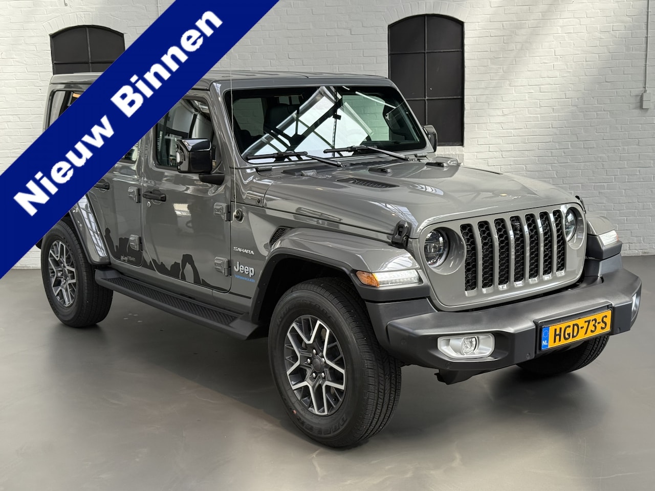 Jeep Wrangler Unlimited - 4xe 380 Sahara 272pk CABRIOLET / CAMERA / STUUR EN STOELVERWARMING / LEER - AutoWereld.nl