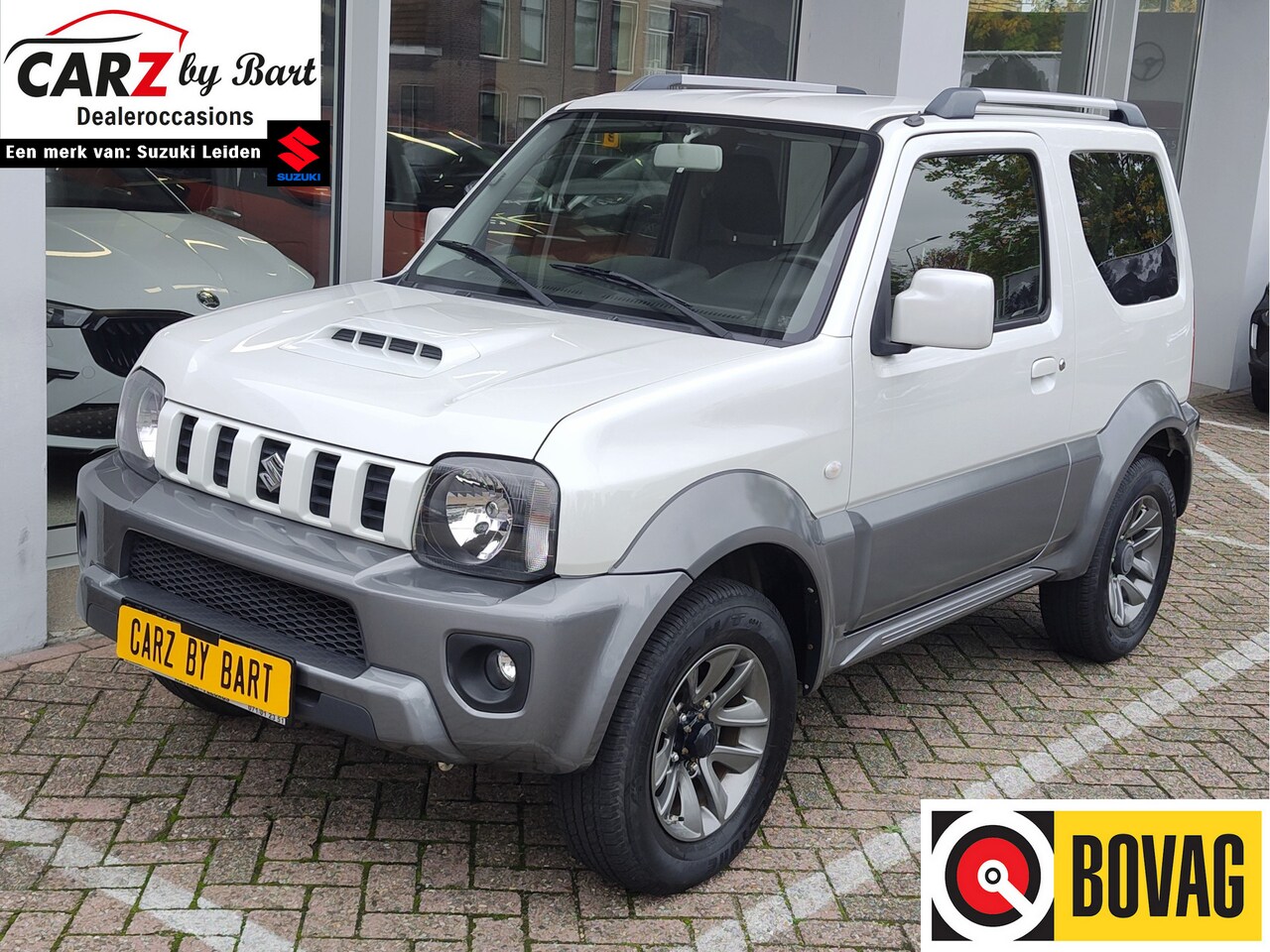 Suzuki Jimny - 1.3 EXCLUSIVE 4WD Trekhaak | Leder | Airco | Lichtmetalen velgen - AutoWereld.nl