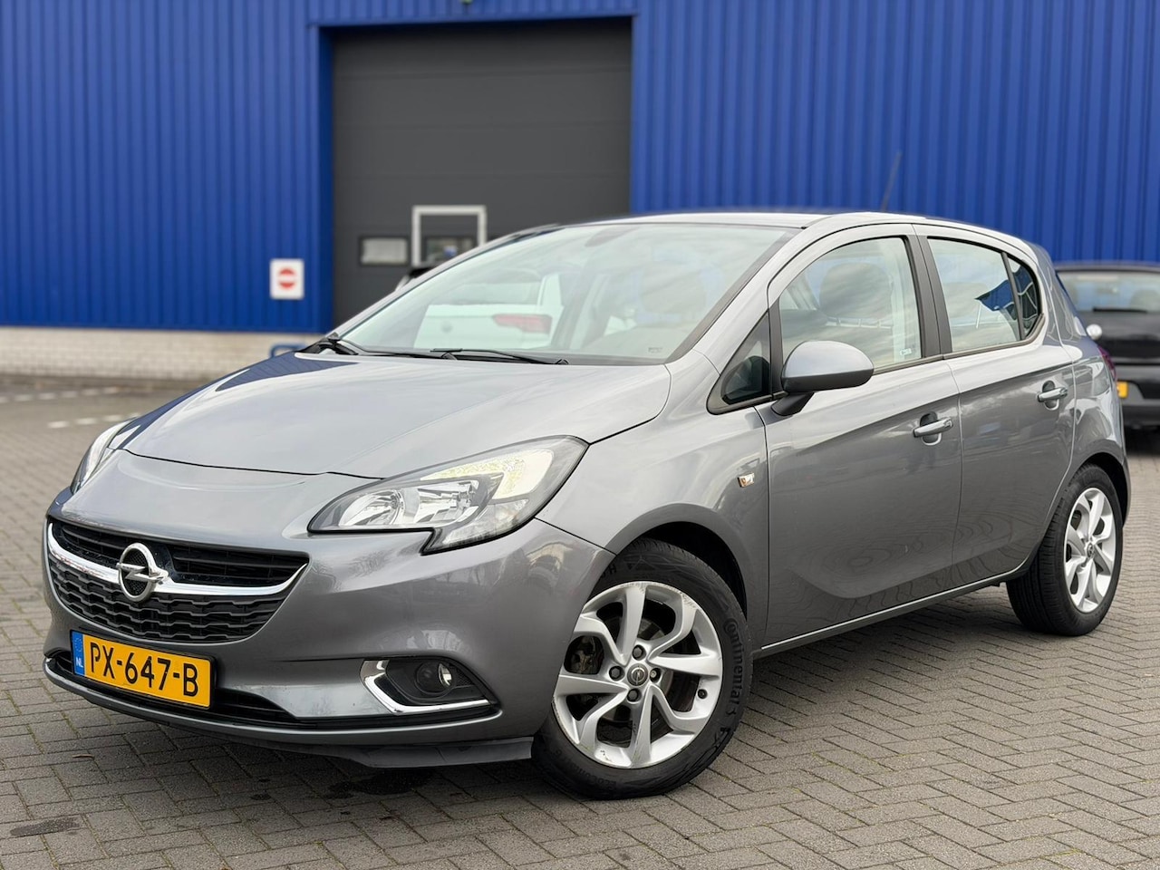 Opel Corsa - 1.4 Online Edition/Airco/Cruise/LMV/Navi/NAP/PDC - AutoWereld.nl