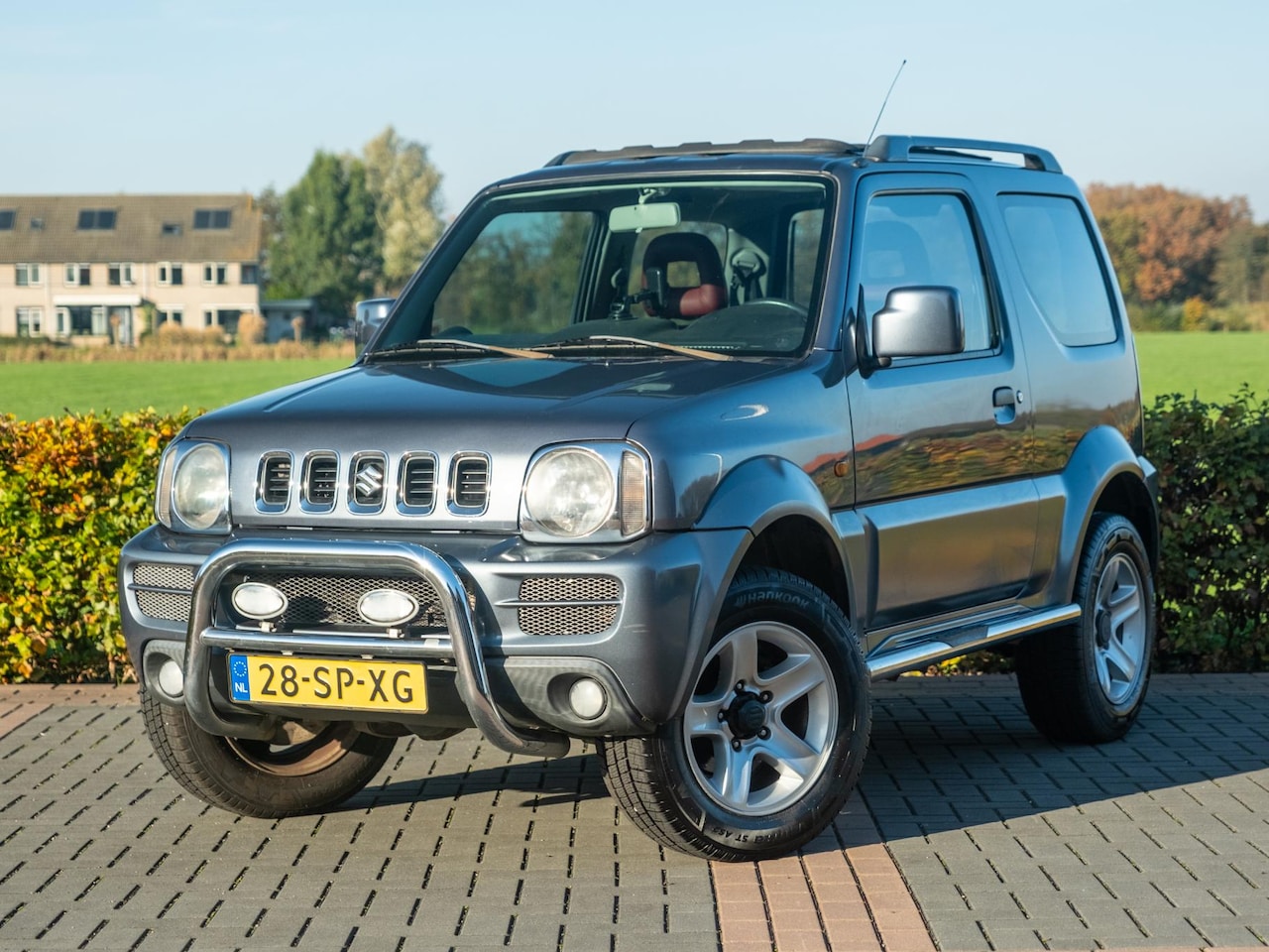 Suzuki Jimny - 1.3 Exclusive | Volleder | Stoelverwarming | Airco | Pano roldak | Afn Trekhaak | Chroom p - AutoWereld.nl