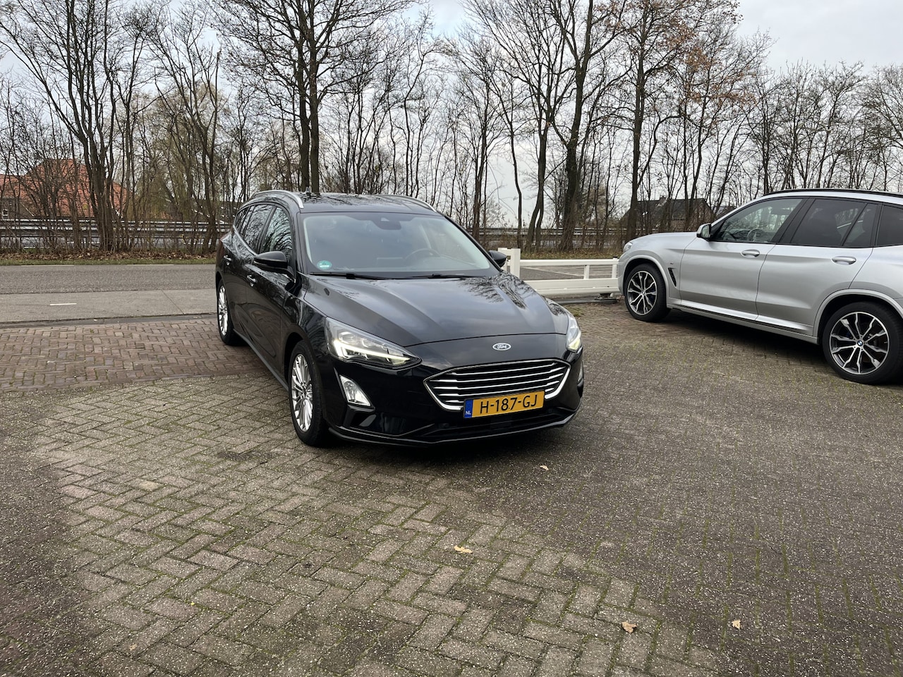 Ford Focus Wagon - 1.0 EcoBoost Titanium Business TREKHAAK CLIMA STOEL- EN STUURVERWARMING - AutoWereld.nl