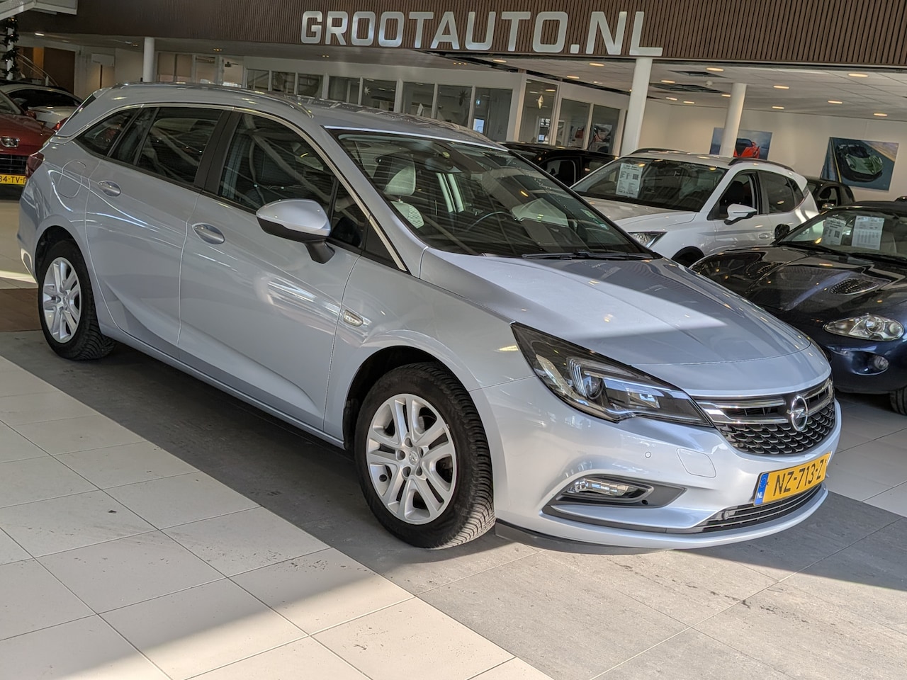 Opel Astra Sports Tourer - 1.4 Online Edition Airco, Cruise Control, Navigatie, Trekhaak, Stuurbekrachtiging - AutoWereld.nl