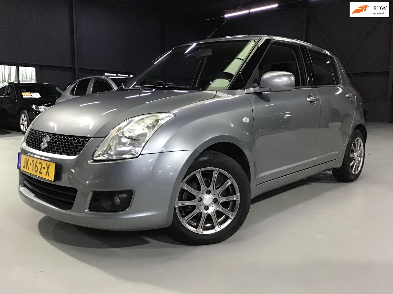 Suzuki Swift - 1.3 Comfort I New Koppeling + Remmen + Beurt I Apk 8-'26 I 5 Drs I 15inch I Isofix I Elec - AutoWereld.nl