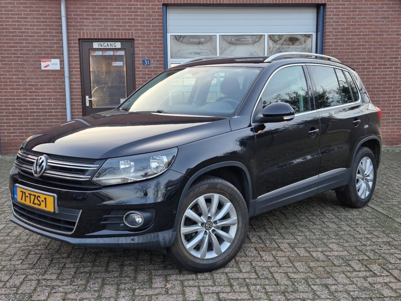 Volkswagen Tiguan - 1.4 TSI SportenStyle NL-auto 1-eig. Climate Cruise Trekhaak - AutoWereld.nl