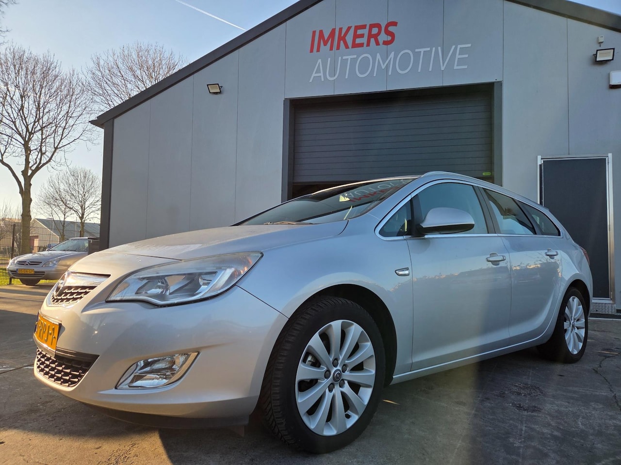 Opel Astra Sports Tourer - 1.4 Turbo Cosmo PDC | Navi | Leer - AutoWereld.nl