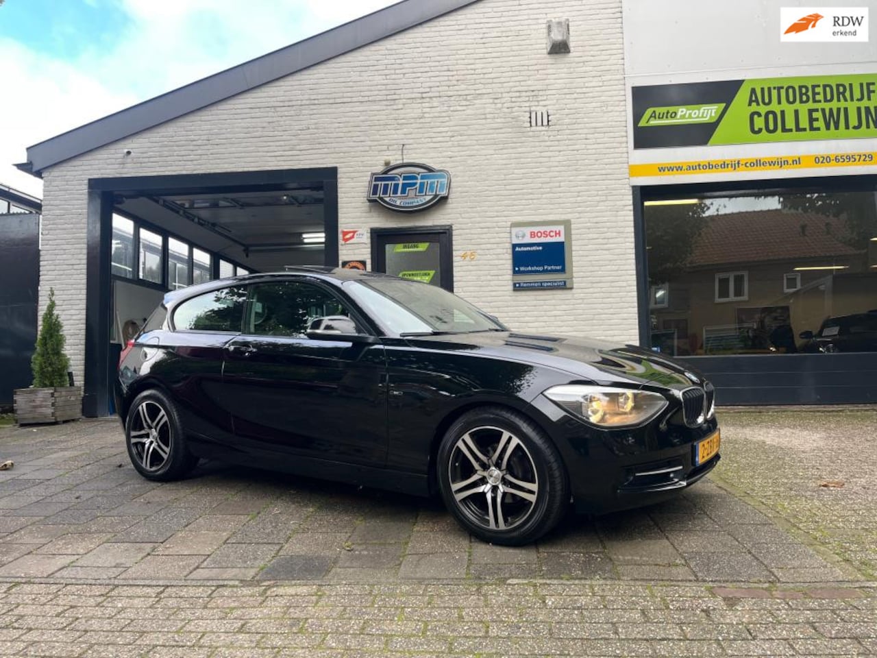 BMW 1-serie - 114i Business+ Sport Zwart 2012 Schuifdak - AutoWereld.nl