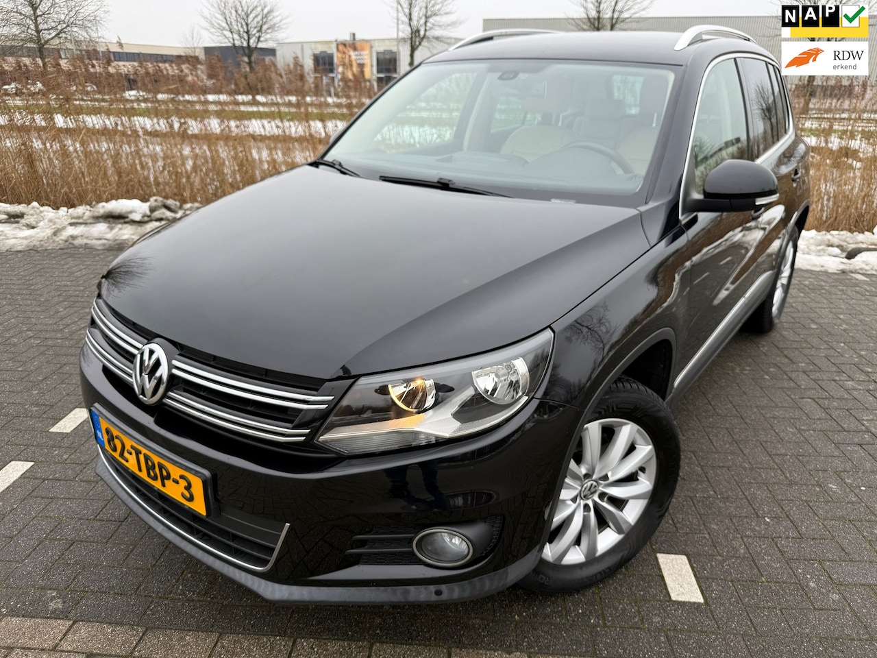 Volkswagen Tiguan - 1.4 TSI Sport&Style*CRUISE*AIRCO*LEER*NAVI*PARK SENSOREN*VELGEN*STOEL VERWARMING - AutoWereld.nl