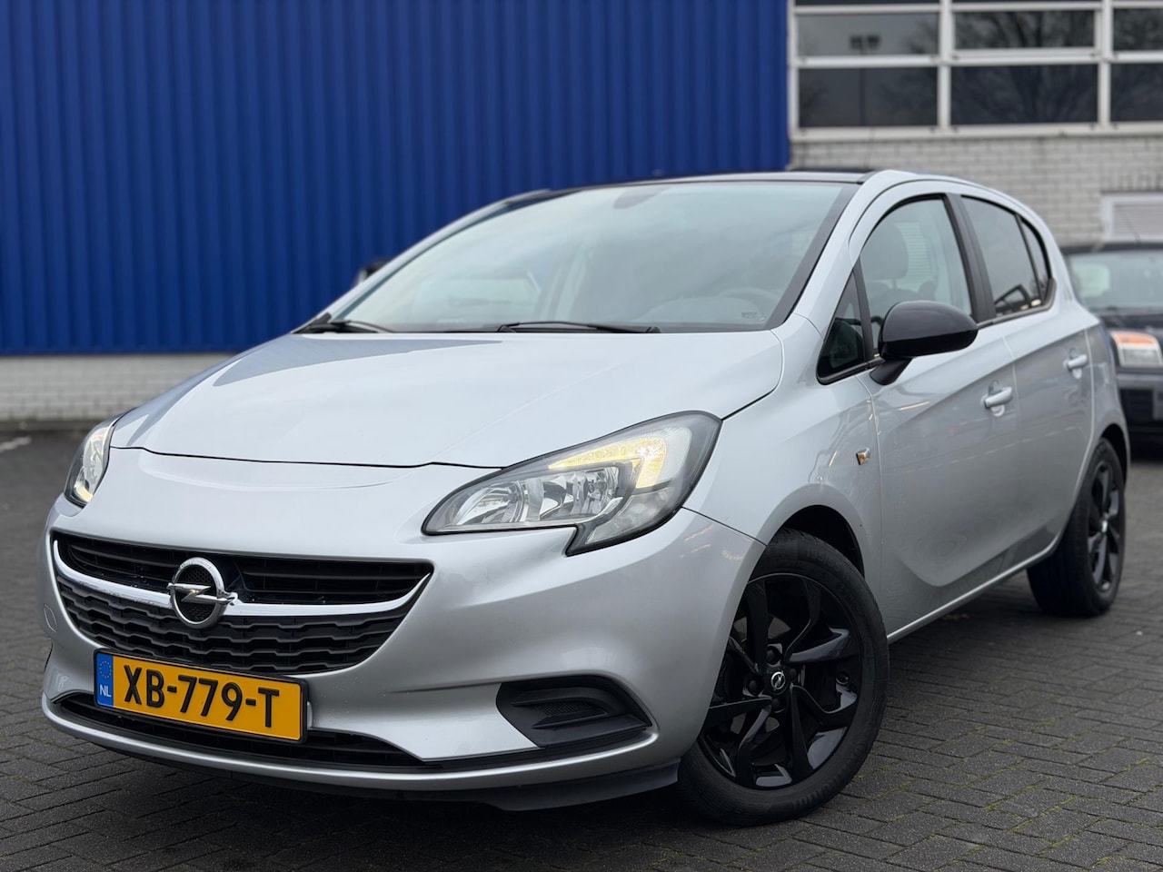 Opel Corsa - 1.4 Black Edition Airco Cruise Navi PDC - AutoWereld.nl