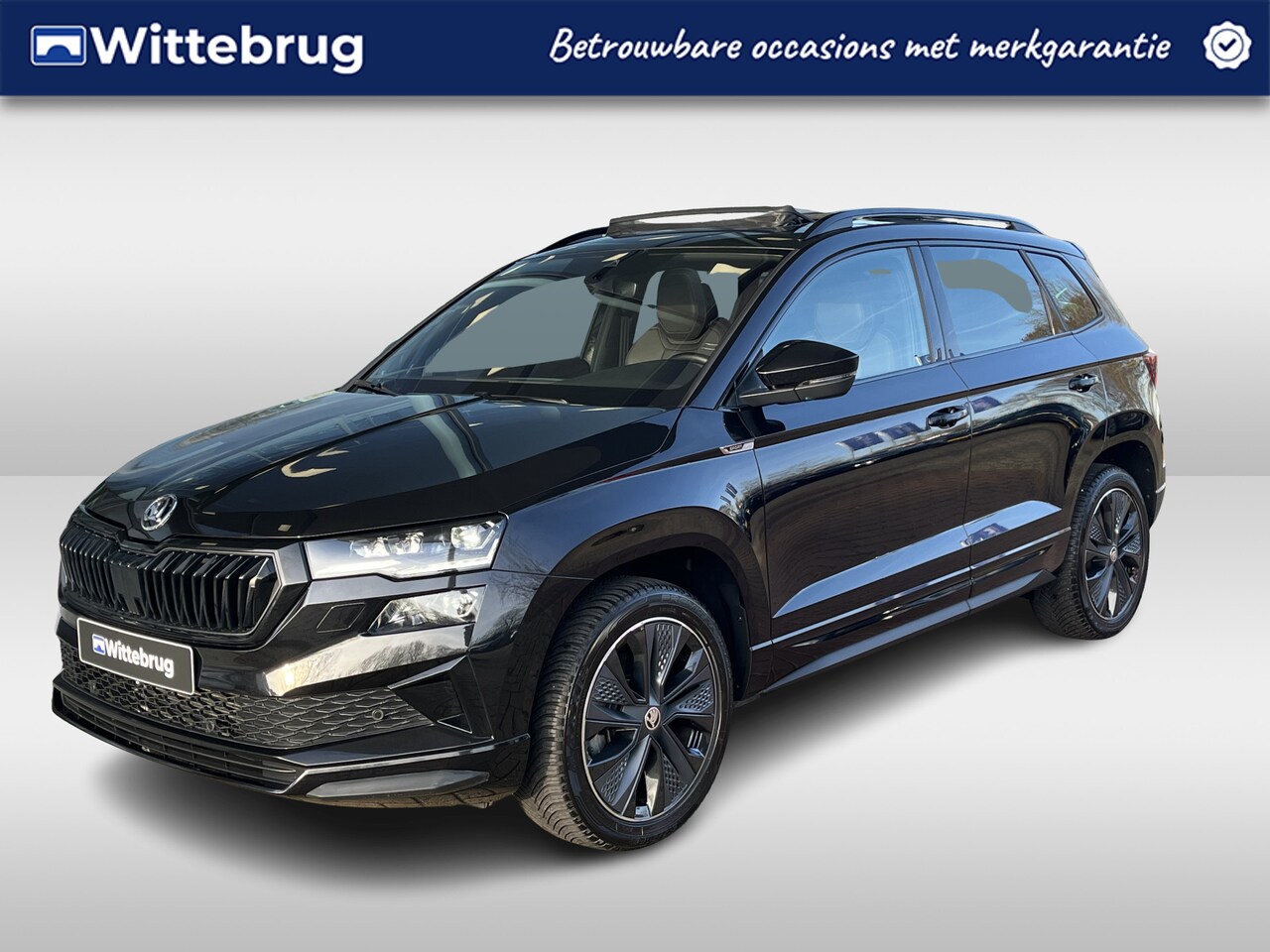 Skoda Karoq - 1.5 TSI DSG Sportline Business / Panorama dak / Ledere bekleding / Geheugen stoel / 18'' L - AutoWereld.nl