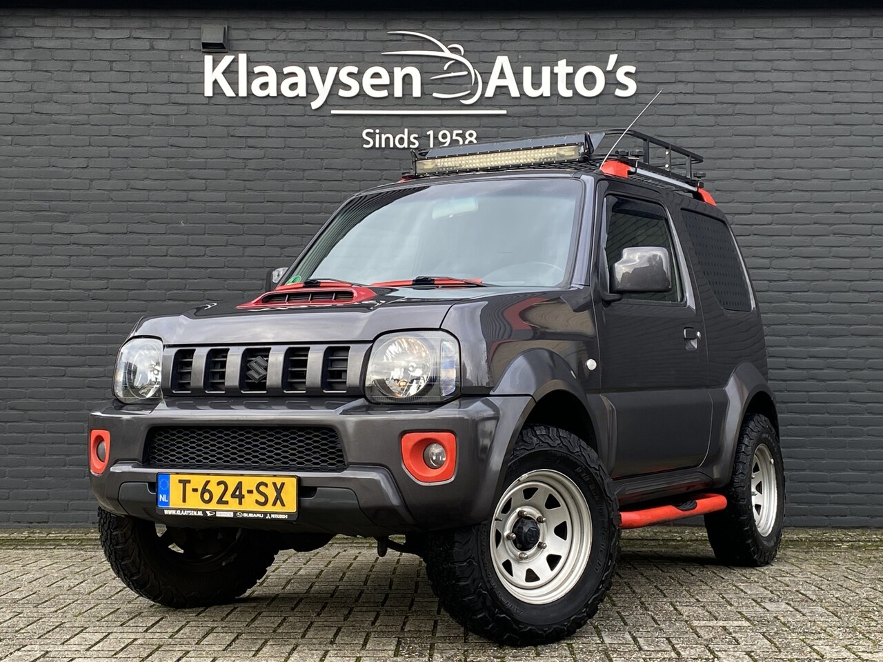 Suzuki Jimny - 1.3 4WD Exclusive | leder interieur | airco | trekhaak | stoelverwarming | imperiaal | ele - AutoWereld.nl