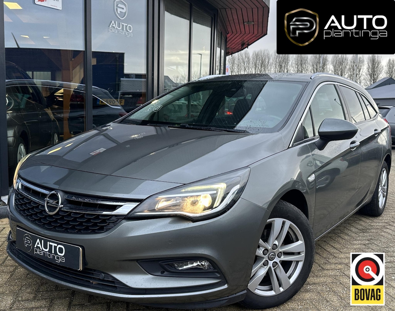 Opel Astra Sports Tourer - 1.4 Turbo 120 Jaar Edition 150PK | AUTOMAAT | ZEER NETTE STAAT | Trekhaak | Stoel en Stuur - AutoWereld.nl