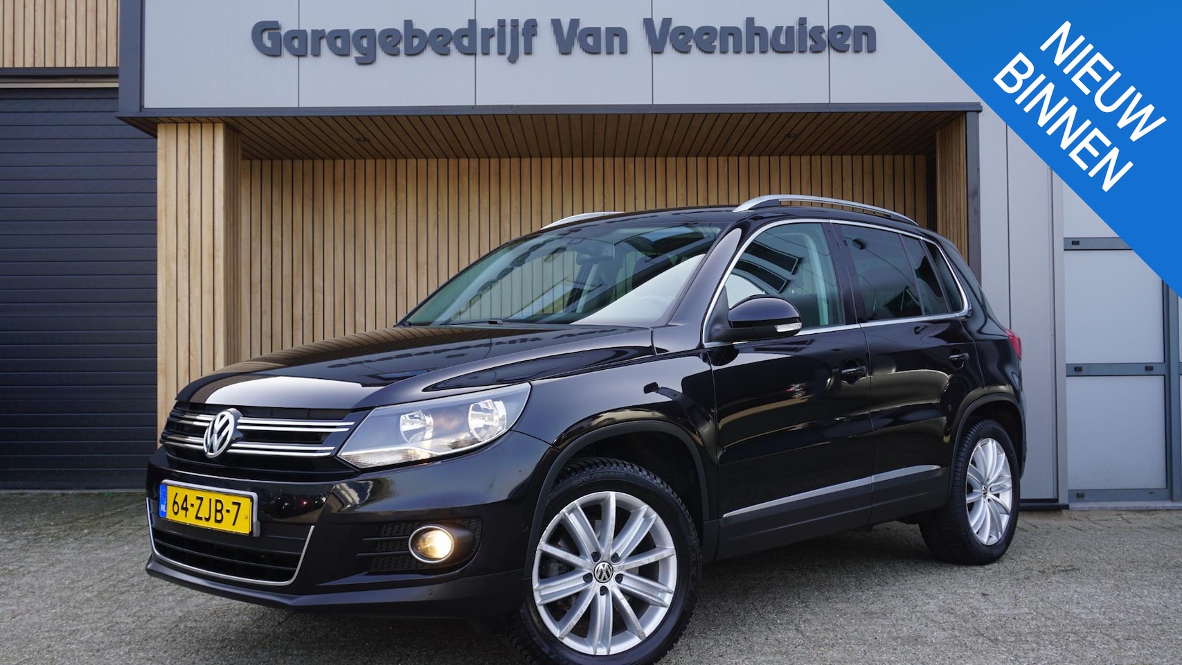 Volkswagen Tiguan - 1.4 TSI 122pk Sport&Style Clima Cruise 18 inch LM *158500km* NL auto PDC Navi *2de eign* - AutoWereld.nl