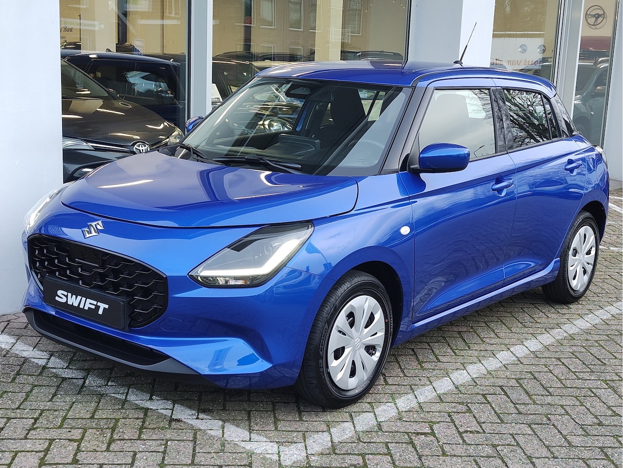 Suzuki Swift - 1.2 COMFORT SMART HYBRID | DEMO DEAL! | Garantie tot 2035! - AutoWereld.nl