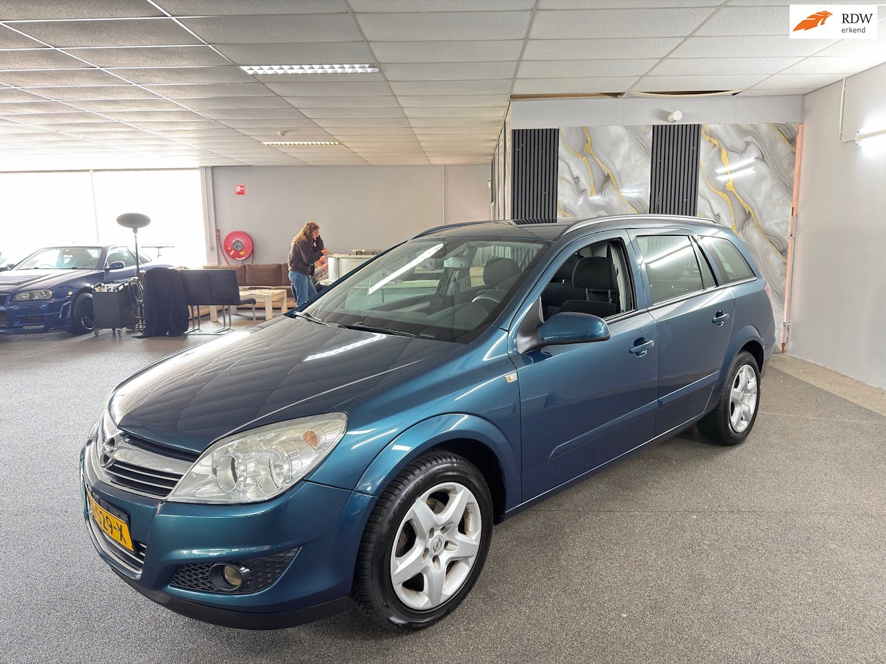 Opel Astra Wagon - 1.8 Essentia Apk Nieuw,Clima,Cruise,N.A.P,Lm velgen,Trekhaak,Dakdragers,2 sleutels,Topstaa - AutoWereld.nl