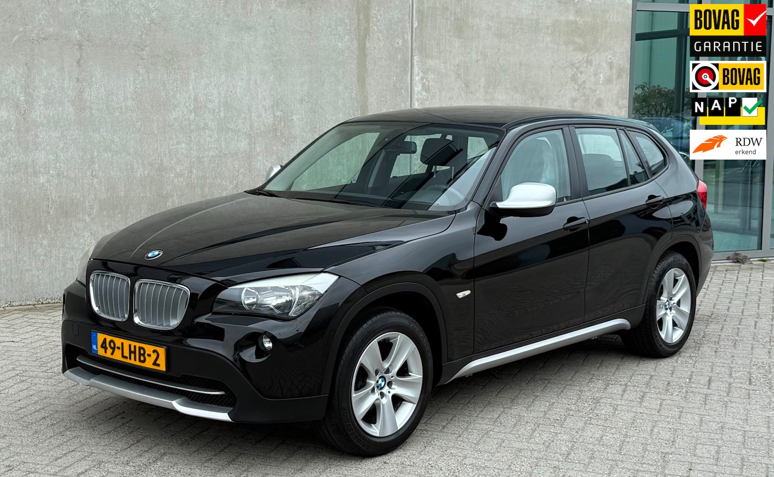 BMW X1 - SDrive18i 150pk 2010 Zwart NAP|TREKHAAK|APK 2027 - AutoWereld.nl