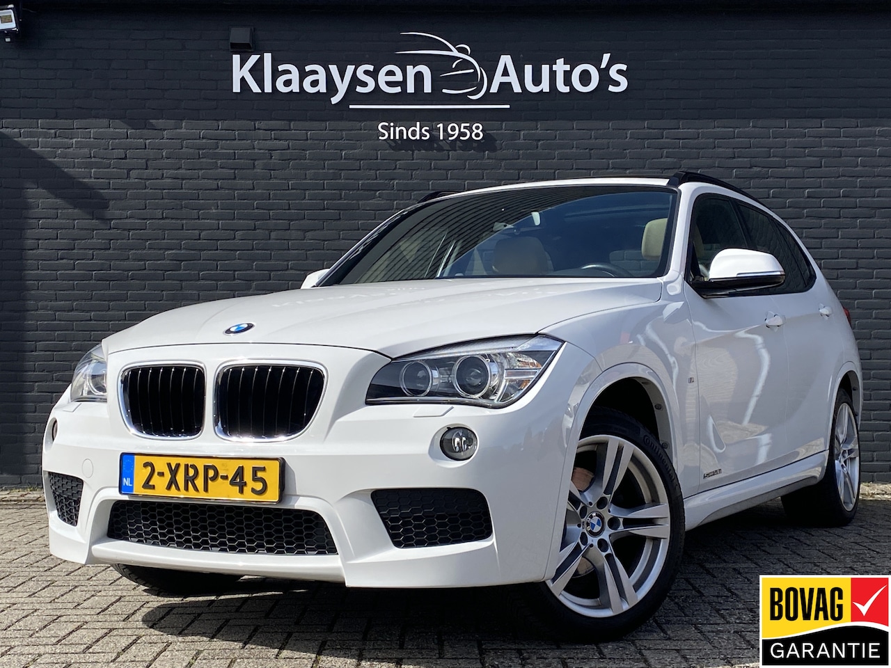 BMW X1 - sDrive20i High Executive 184 pk AUT. | panoramadak | navigatie | trekhaak | beige leder in - AutoWereld.nl
