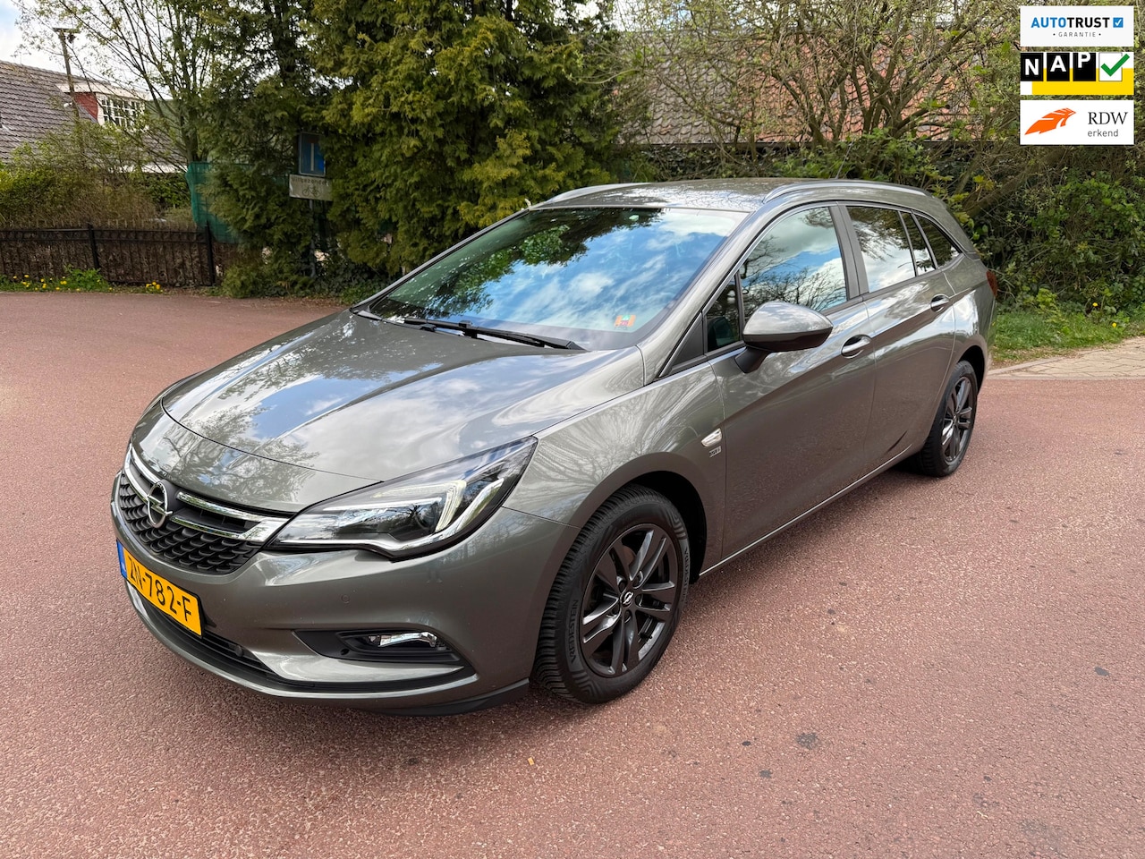 Opel Astra Sports Tourer - 1.0 Turbo 120 Jaar Edition Airco / Navi / PDC / NAP / APK - AutoWereld.nl