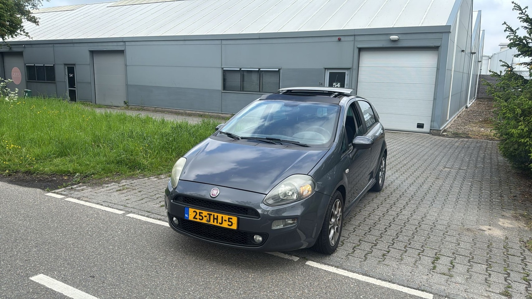 Fiat Punto Evo - 1.3 M-Jet Lounge PANORAMA DAK CLIMA GRIJS 2012 - AutoWereld.nl