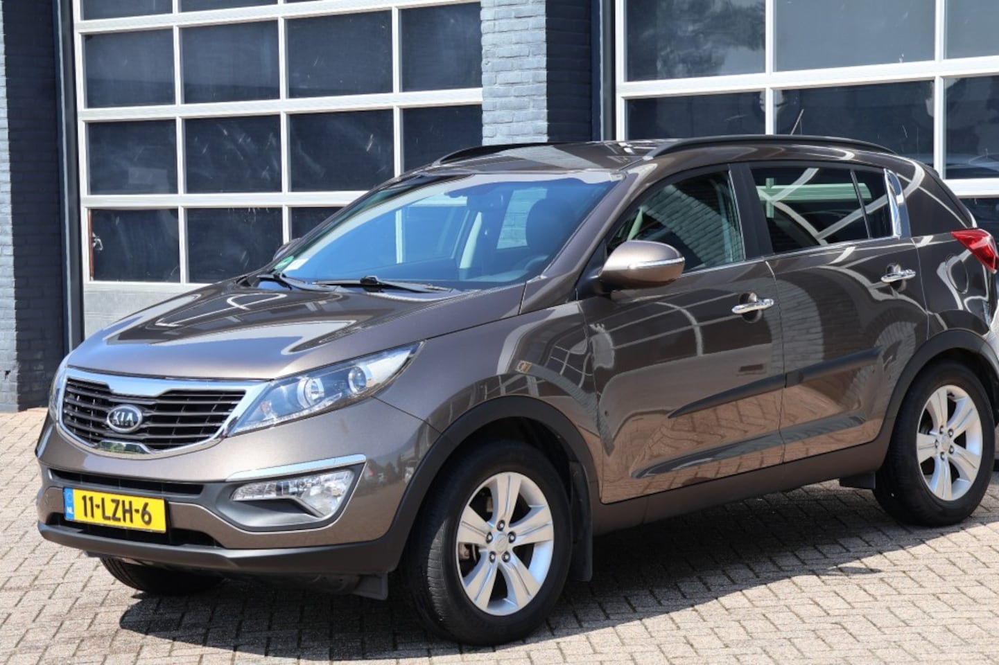 Kia Sportage - 2.0 X-clusive half leder, cruise control ,NAP - AutoWereld.nl
