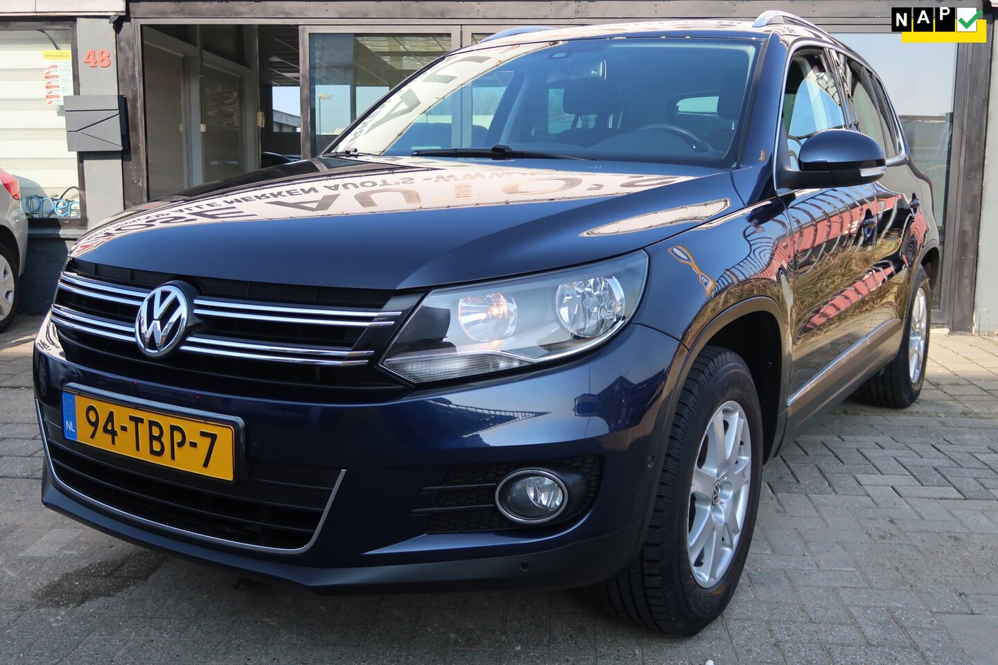 Volkswagen Tiguan - 1.4 TSI Sport&Style *Rijklaarprijs *Trekhaak *Dealeronderhouden - AutoWereld.nl