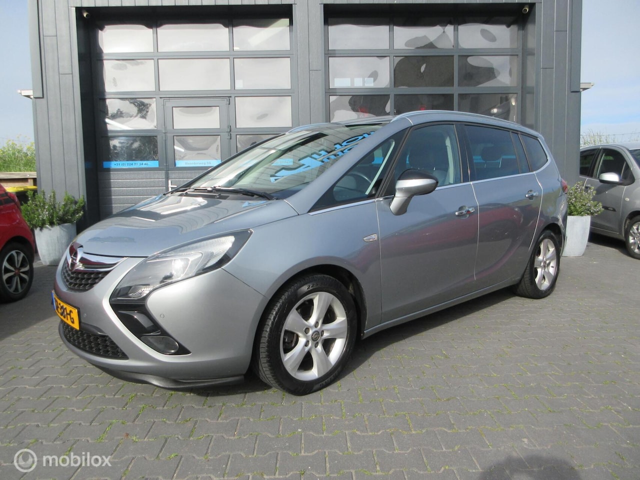 Opel Zafira Tourer - 1.4 Cosmo 7p. Airco Cruise Trekhaak Navi - AutoWereld.nl