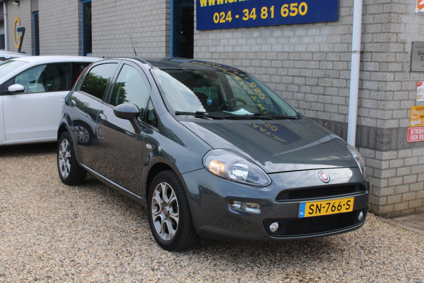 Fiat Punto Evo - 0.9 TwinAir Sempre Clima Navi Trekhaak - AutoWereld.nl
